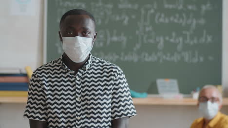 Portrait-of-African-Student-in-Face-Mask-in-Classroom