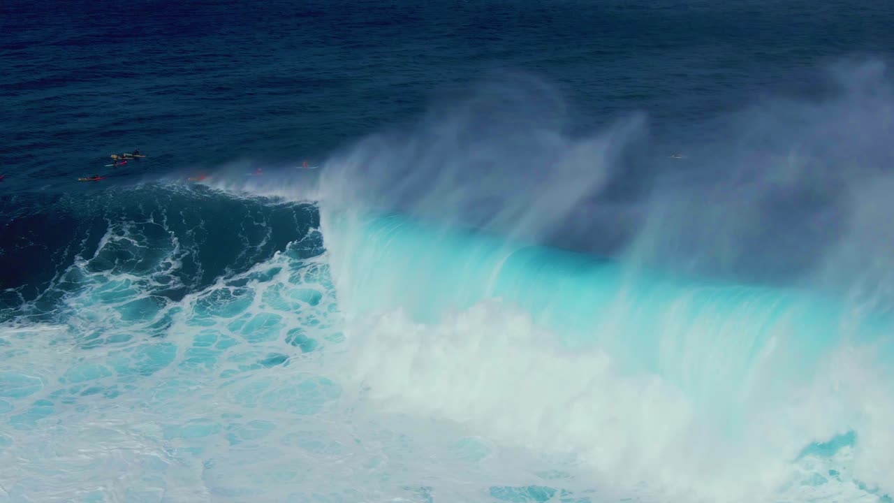 Big wave rolling from above, drone view on blue turquoise ocean with breaking waves whitewash to shoreline, Hawaii