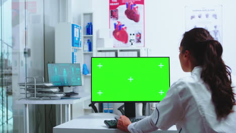 Doctor-using-computer-with-green-mockup