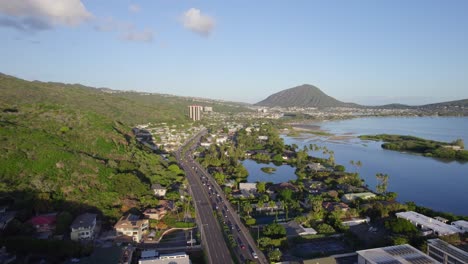 aerial footage traveling on highway h1 in honolulu hawaii on the island of oahu with mamala bay off to the right on a sunny afternoon