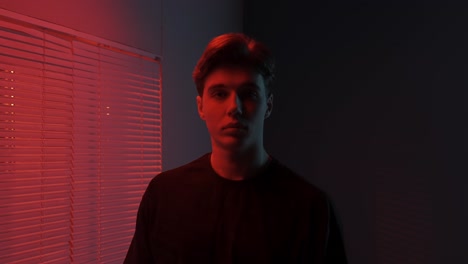 studio portrait of a teenager in red and blue light