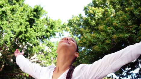 Beautiful-woman-raising-arms-and-enjoying-outdoors