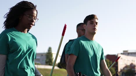 Volunteers-with-rakes-talking-in-park