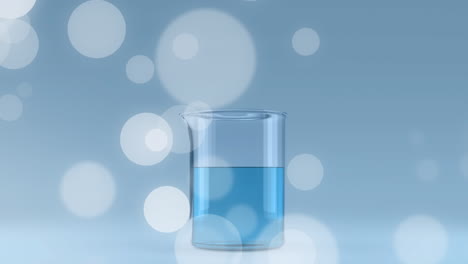 animación de las llamaradas de la lente y el vaso lleno de líquido azul contra un fondo azul