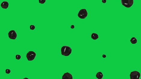pequeño montón de bolas de tapioca marrón brillante levitando frente a la pantalla verde