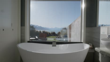 chic window bath tub with spectacular mountain views in sunshine