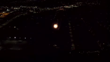 aerial shot of fireworks with city lights in the background.  city night lights.  4k footage.