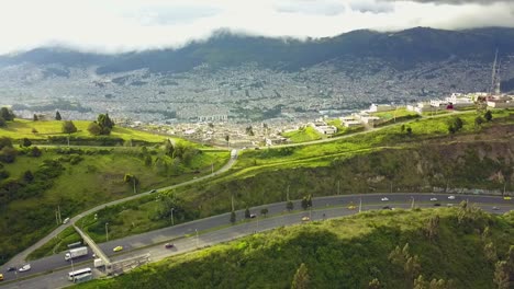 scenic highway with view to quito city skyline and andes mountain range, aerial view