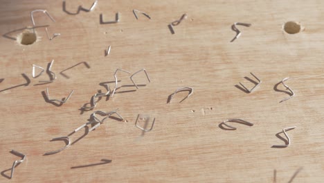 stainless steel staples bounce off plywood artistically