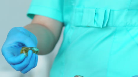 close - up of hands in rubber gloves to knead sugar for hair removal fingers for sugaring