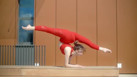 woman performing acrobatic yoga poses outdoors