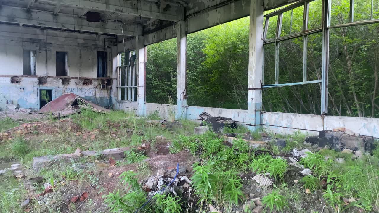 Dilapidated interior with broken windows and decaying walls