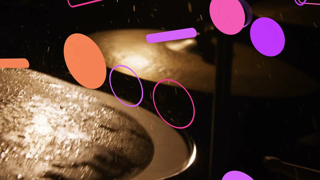 Two metallic cymbals on stands catching warm backlight, water droplets shifting, graphics drifting