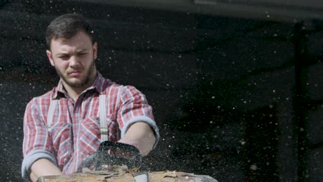 man chopping wood with chainsaw