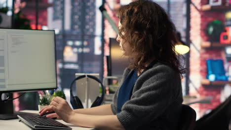 young woman programming software code on her computer