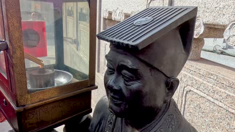 statue near incense burner in hong kong temple