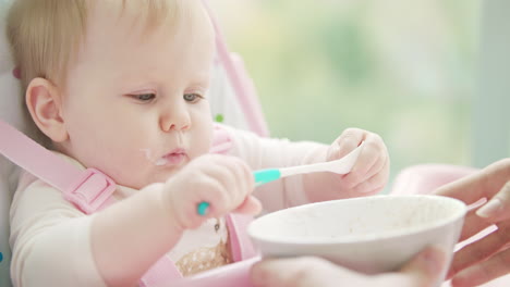 Little girl playing with spoon