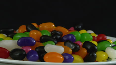 Macro-view:-close-up-Jelly-Belly-candies-rotate-on-black-background