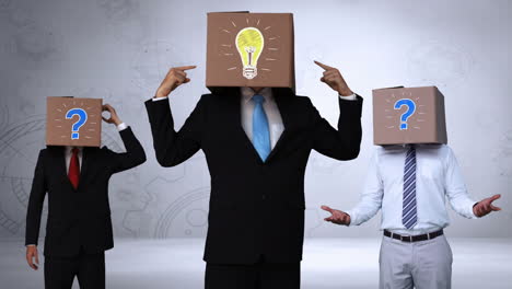 Team-of-businessman-hiding-head-with-box-and-gesturing