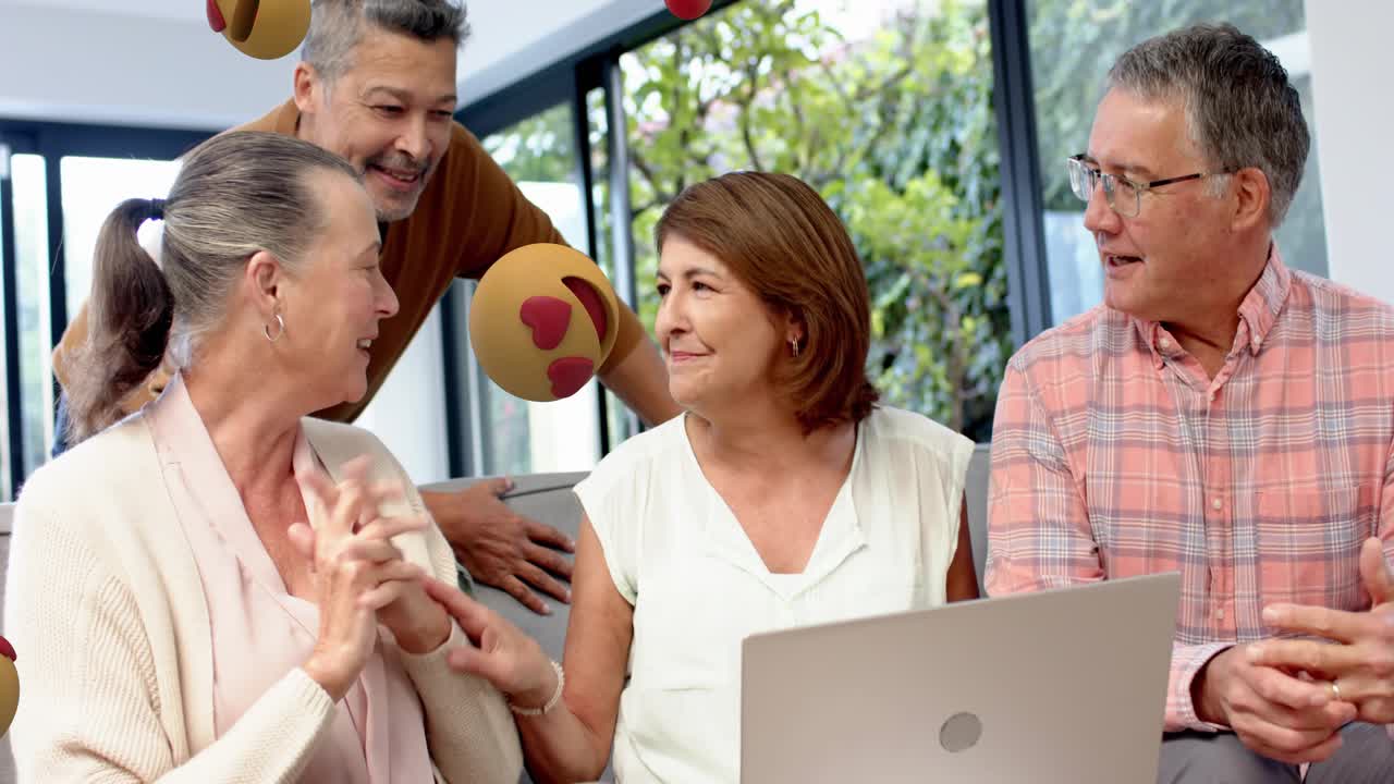 Center woman speaking, group reacting to tech content on laptop, emojis animating around group