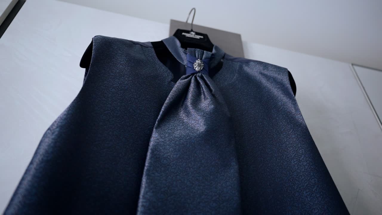 Satin blue fabric with elegant neck detail, soft lighting and stylish design