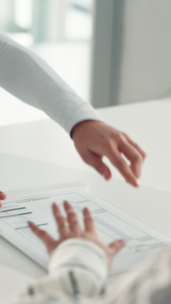 Professional Hands Reviewing Financial Income Statement Document