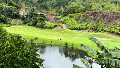 lush green golf course landscape in phuket, thailand with water