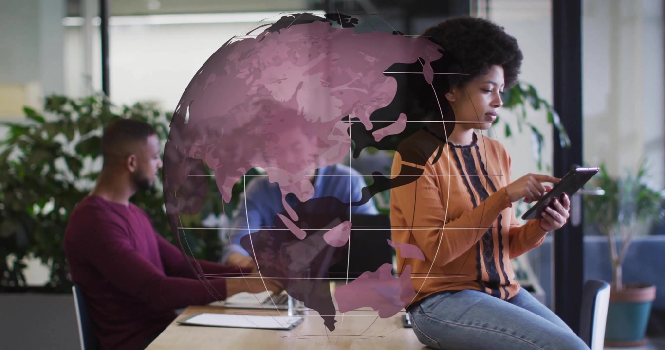 Team using devices and reviewing docs, projecting purple globe during tech meeting