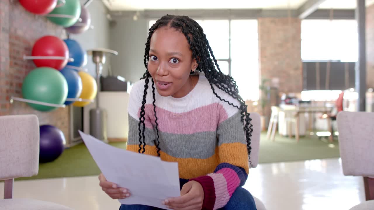 Happy african american casual businesswoman making video call in office