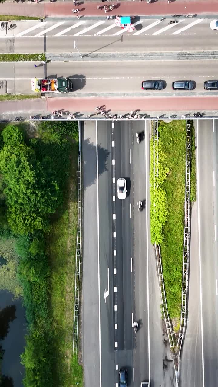 Aerial View of a Cycling Event on a Highway with Spectators