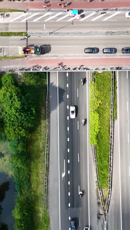aerial view of a cycling event on a highway with spectators