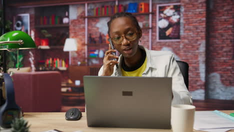 manager in home office arguing with employee during phone call