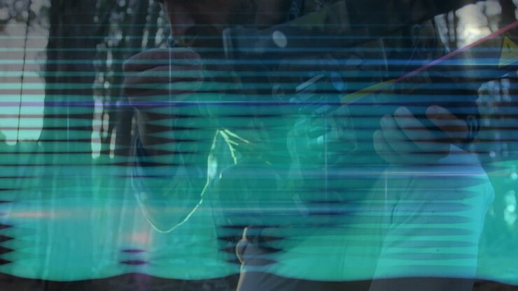 Man threading fishing lure outdoors, showing glitchy teal scan lines for fishing industry
