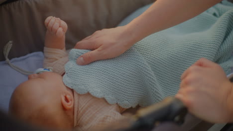mother comforting child in stroller close-up