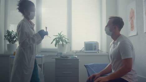 doctor making pcr test patient in office hospital. nurse taking sample from man.