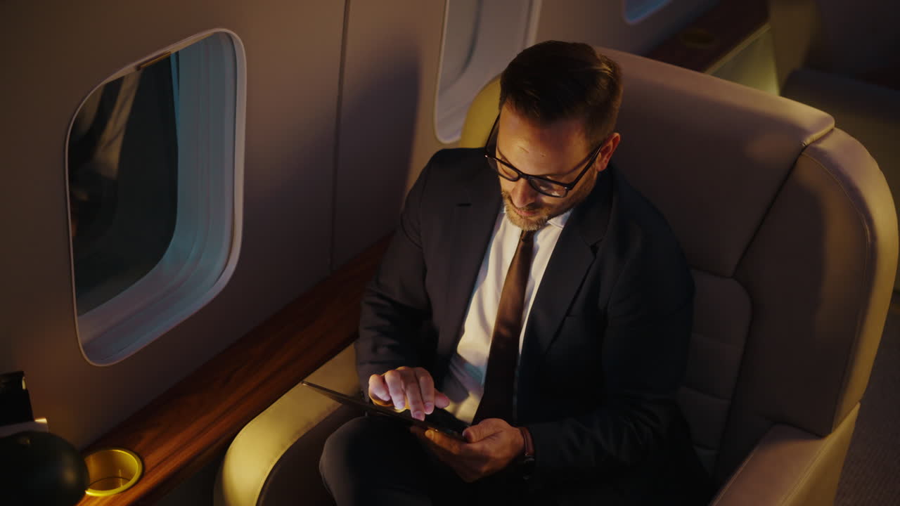 Businessman Using Tablet on Private Jet | Premium Stock Video Footage