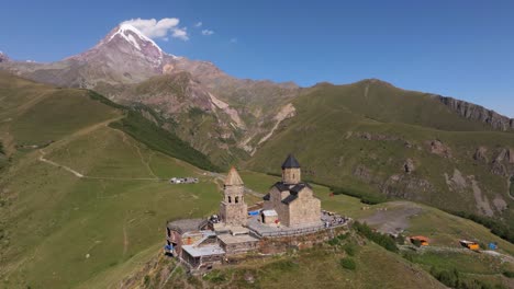 drone orbits above gergeti trinity church, georgia