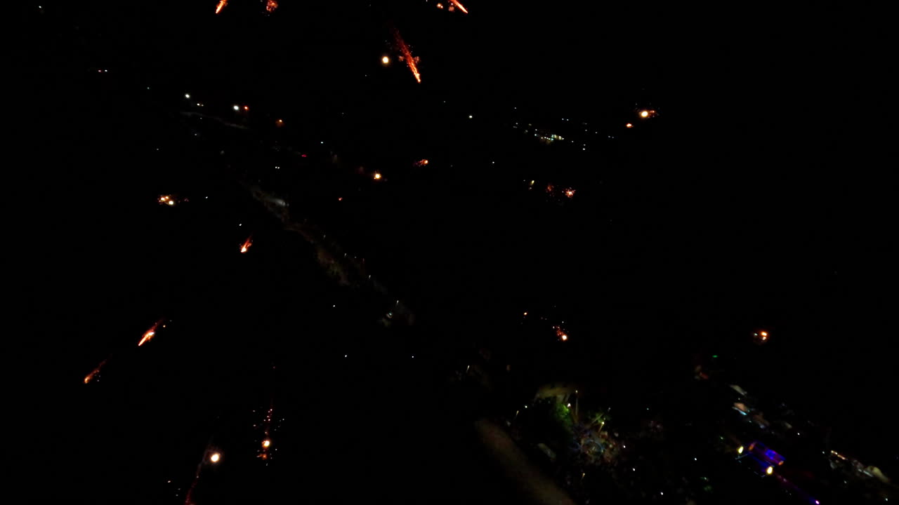 Slow motion fireworks at night, vibrant colors in sky, celebration mood