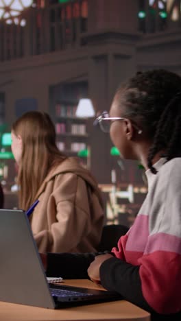 vertical video university student making exam preparations with a friend at the campus library