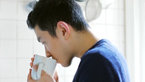 man drinking coffee in kitchen 4k