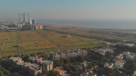 aerial overlooking nooruddin zangi park and arabian sea in karachi. dolly forward