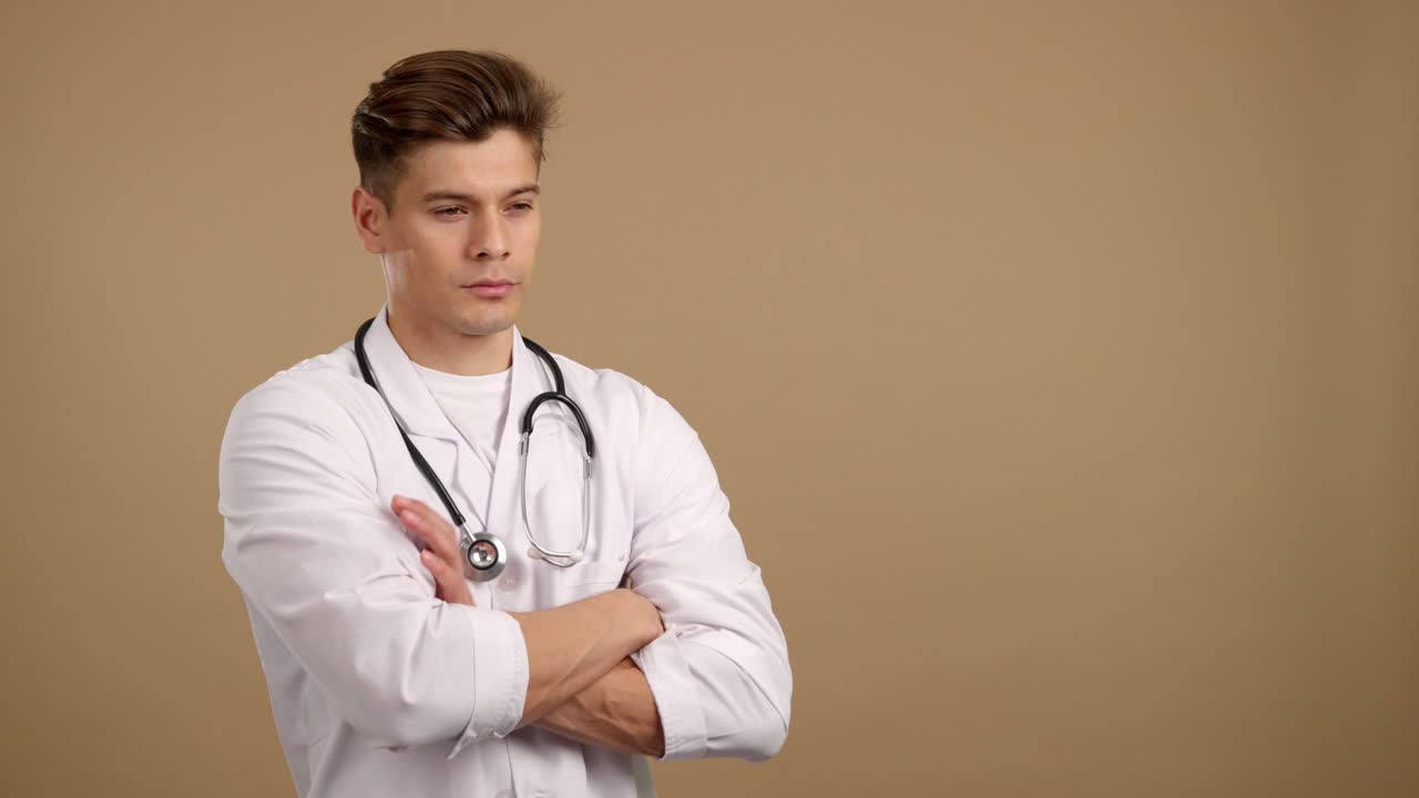Pensive Young Male Doctor with Stethoscope and Crossed Arms