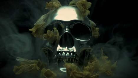 silver skull with dead yellow flowers shrouded by smoke mist, slow motion