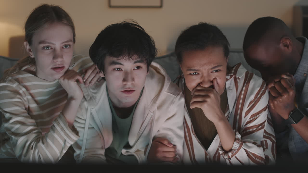 Diverse Friends Watching Thrilling Movie