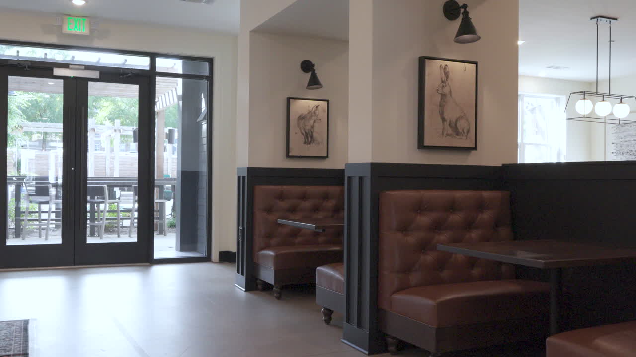 Modern residential lobby with black walls, shelves, and soft seating