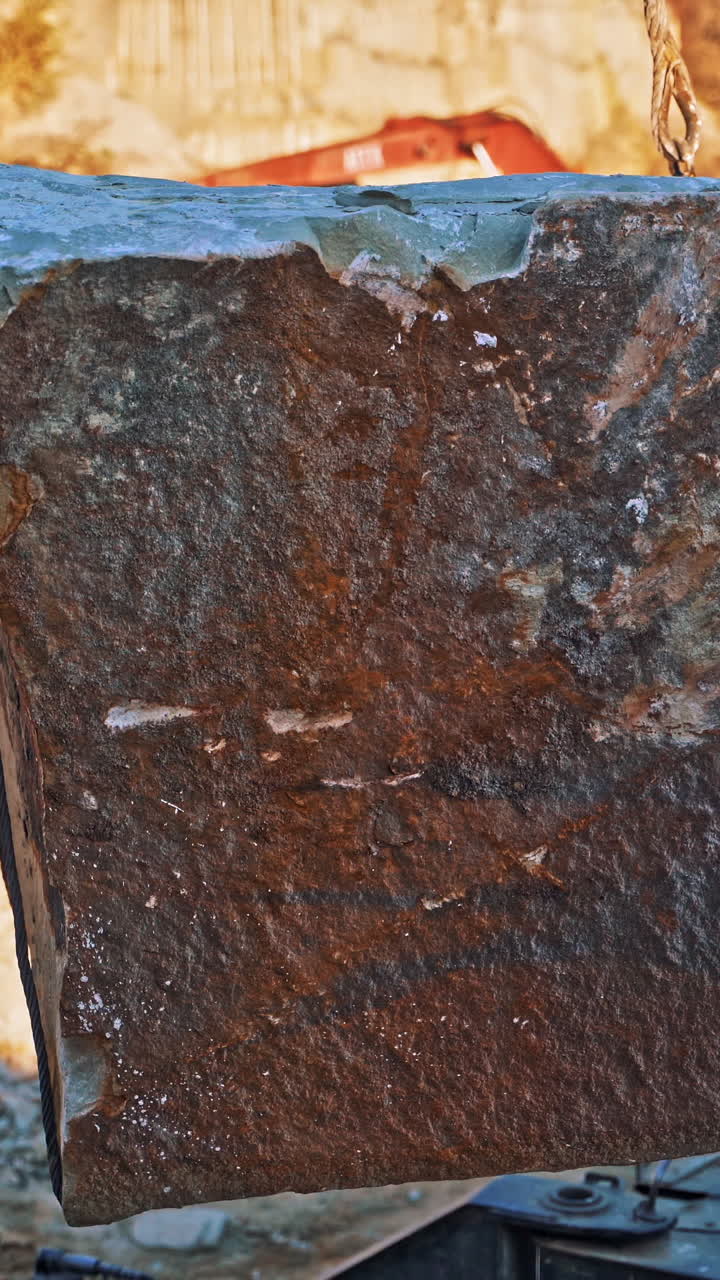 Machinery in quarry of marble extraction. Close up view of crane at work in quarry of marble blocks Vertical video