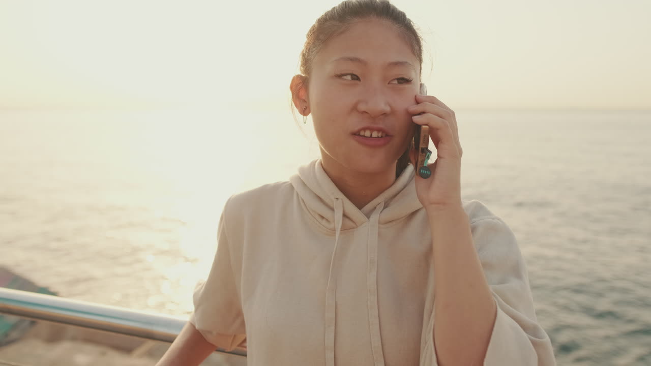 Woman on a phone call by the sea