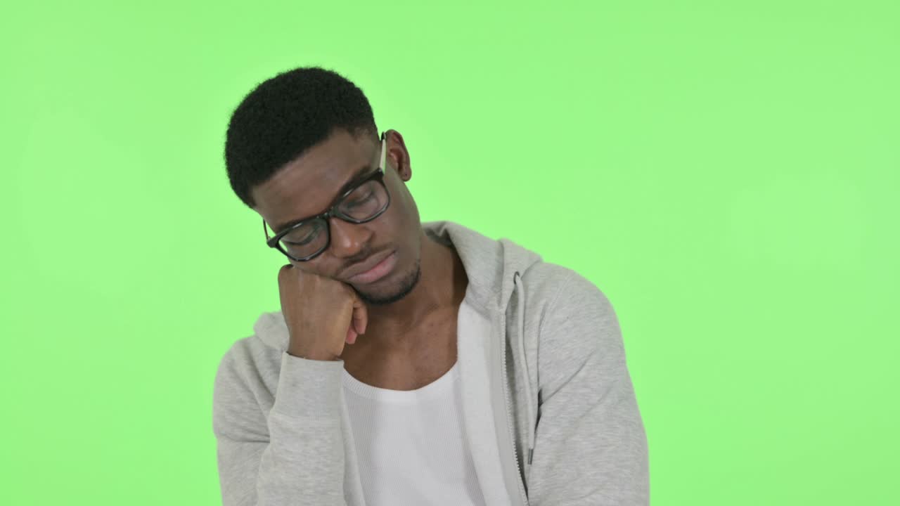 African Man Sleeping on Green Background