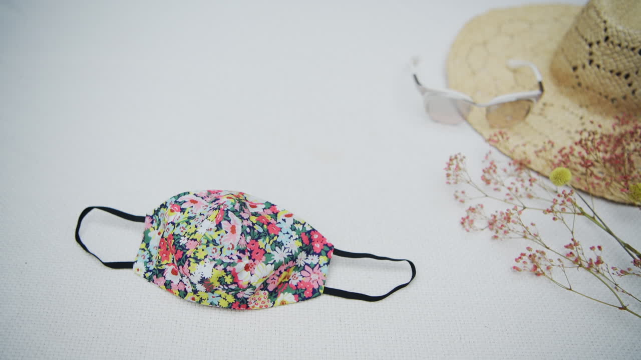 Fabric face mask flat lay on white with copy space, coronavirus concept