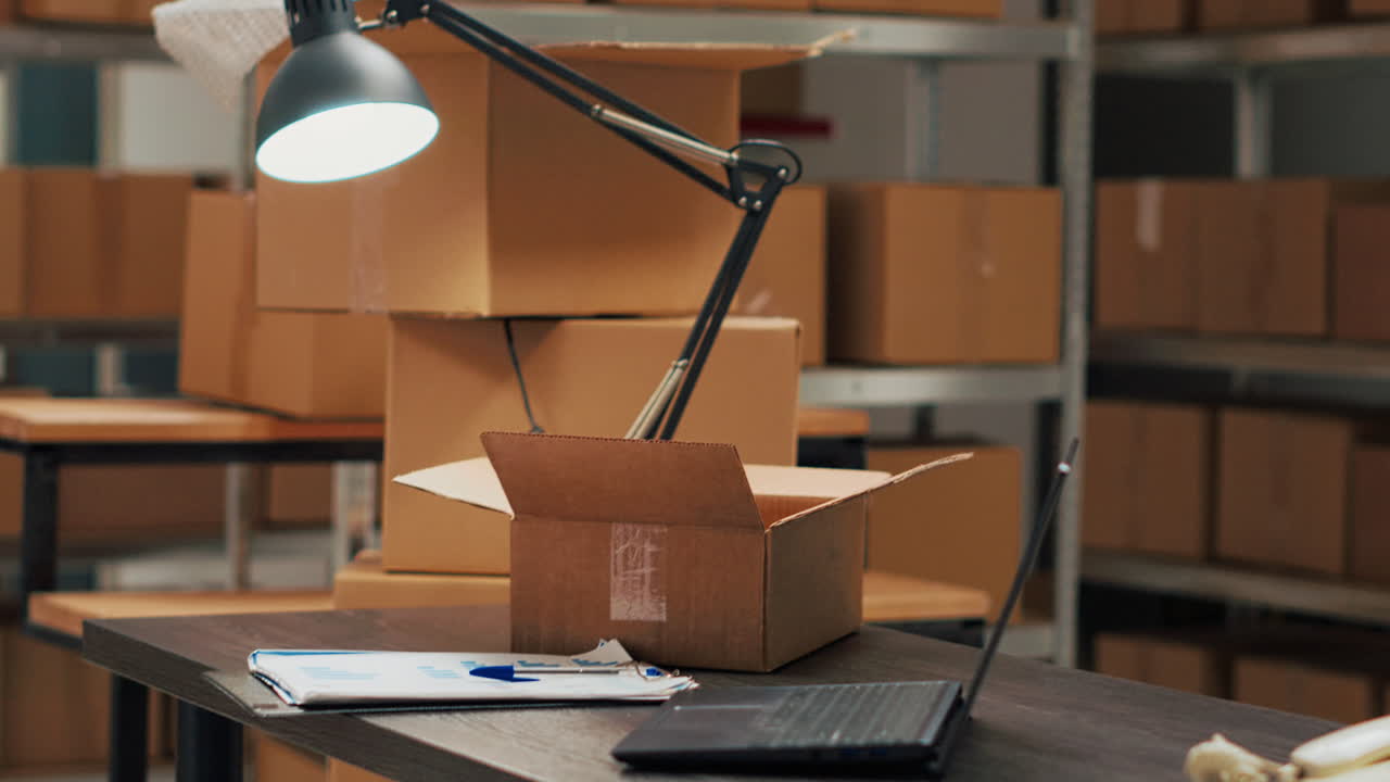 Boxes in a warehouse with a desk and laptop